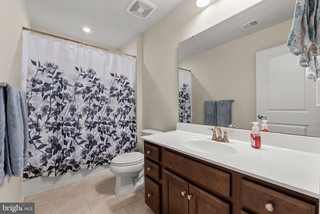 bathroom with tile patterned flooring, vanity, walk in shower, and toilet