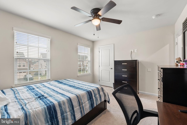 bedroom featuring ceiling fan and light colored carpet