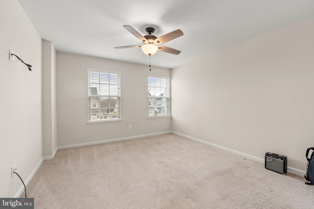 empty room featuring light colored carpet and ceiling fan