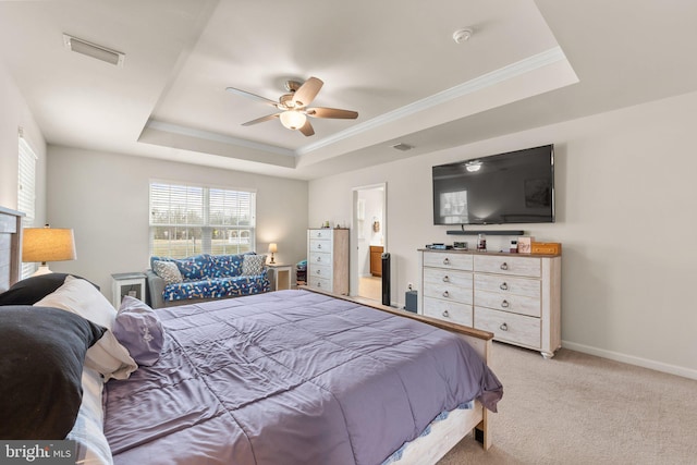 carpeted bedroom with connected bathroom, crown molding, a raised ceiling, and ceiling fan