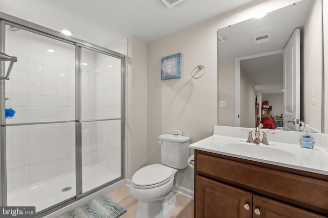 bathroom featuring vanity, a shower with shower door, and toilet