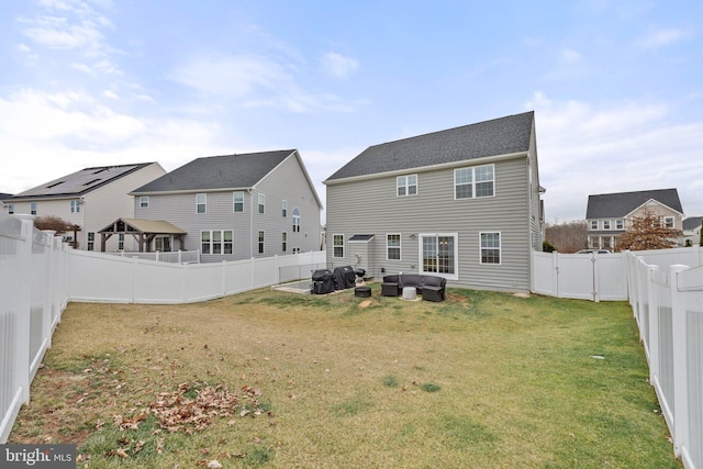 back of property with a yard and an outdoor hangout area