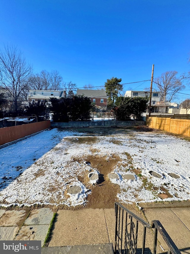 view of yard layered in snow