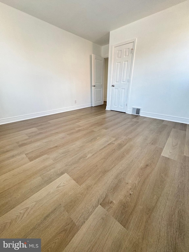 unfurnished room with light hardwood / wood-style flooring