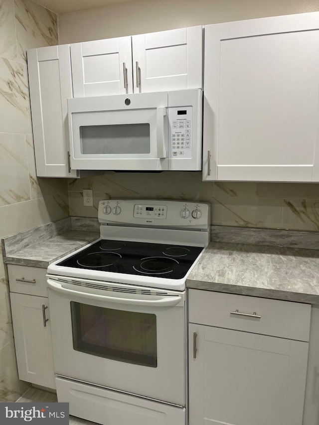 kitchen with white cabinets and white appliances