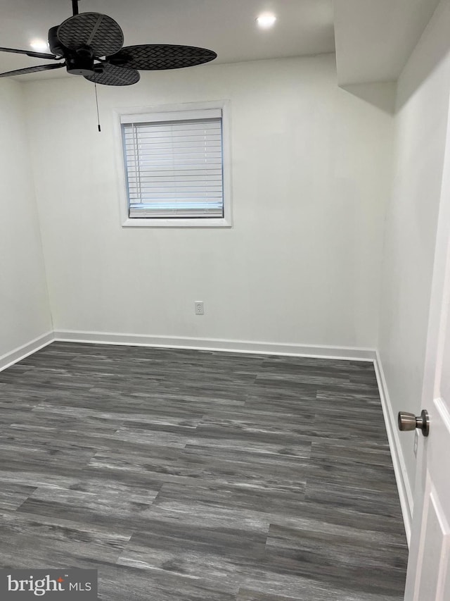 unfurnished room with ceiling fan and dark wood-type flooring