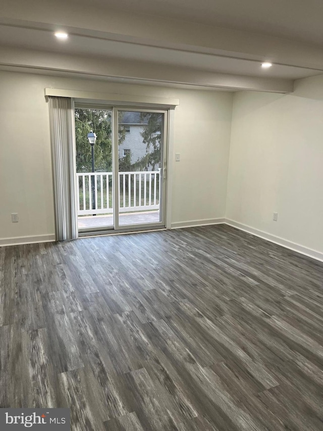 unfurnished room featuring dark wood-type flooring