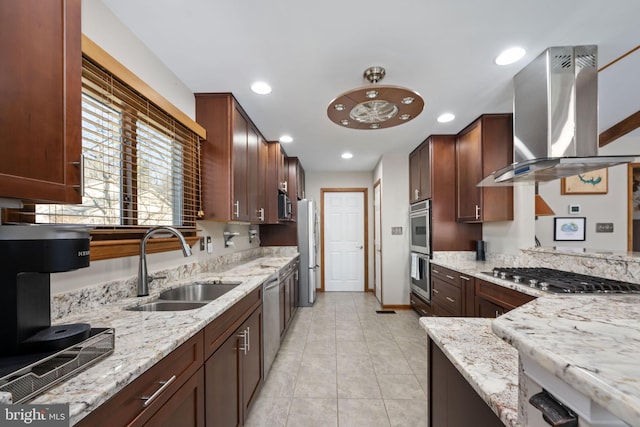 kitchen featuring exhaust hood, sink, appliances with stainless steel finishes, light tile patterned flooring, and light stone counters