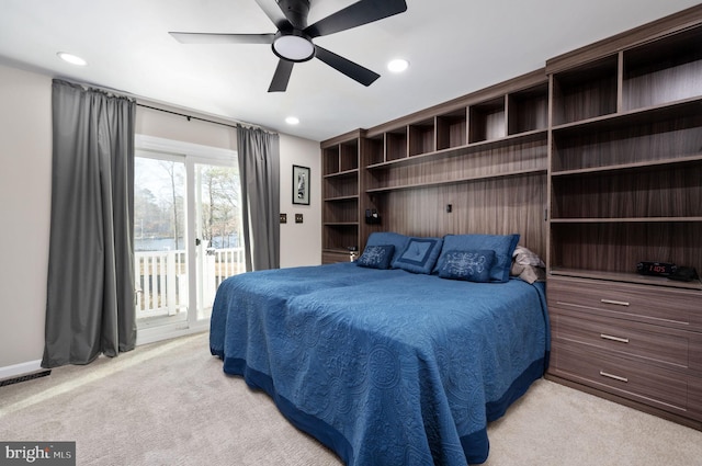 bedroom with access to outside, ceiling fan, and light carpet