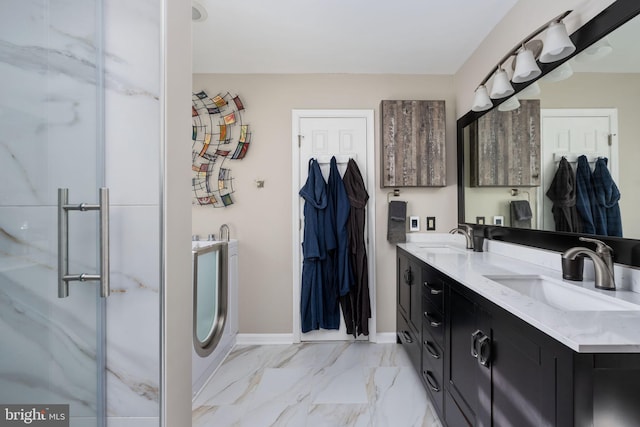 bathroom with washer / dryer, vanity, and an enclosed shower