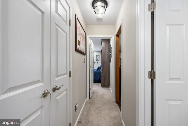 corridor featuring light colored carpet