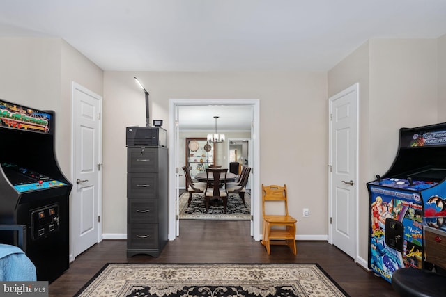 rec room featuring dark hardwood / wood-style flooring and a notable chandelier