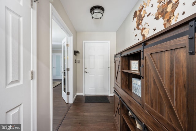 entryway featuring dark hardwood / wood-style flooring and a barn door