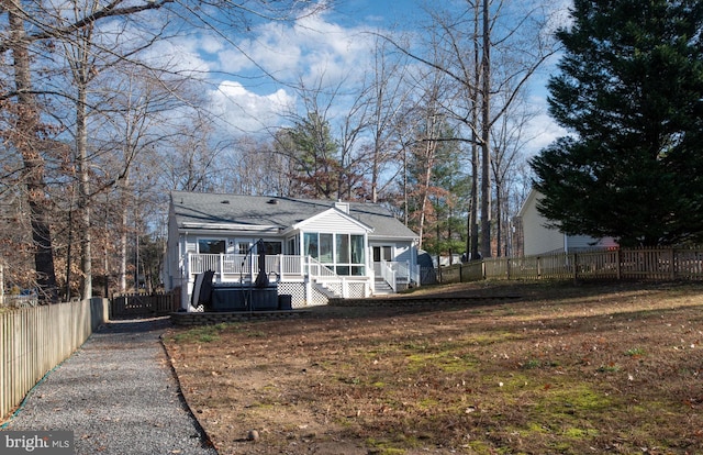 rear view of property with a sunroom