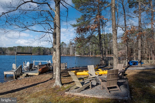 view of yard featuring a water view and a boat dock