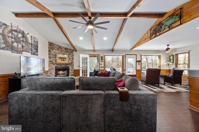 living room with vaulted ceiling with beams, ceiling fan, a fireplace, and dark hardwood / wood-style flooring