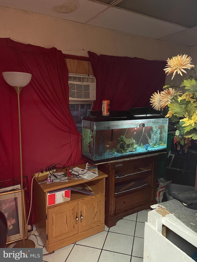 miscellaneous room with light tile patterned flooring and a wall mounted AC