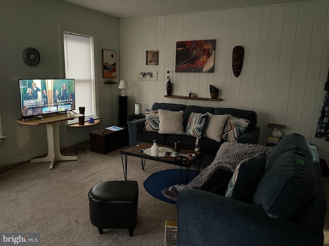 living room featuring wood walls and carpet floors