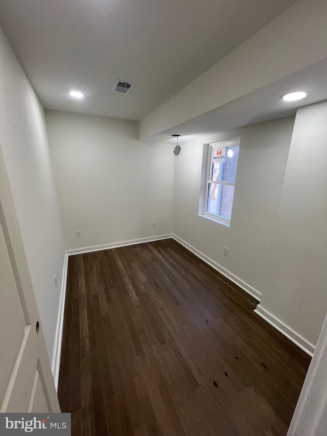 interior space featuring baseboards, visible vents, dark wood-type flooring, and recessed lighting