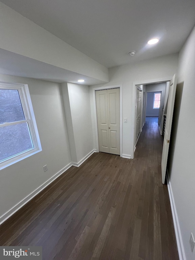 basement with dark wood-style floors, baseboards, and recessed lighting