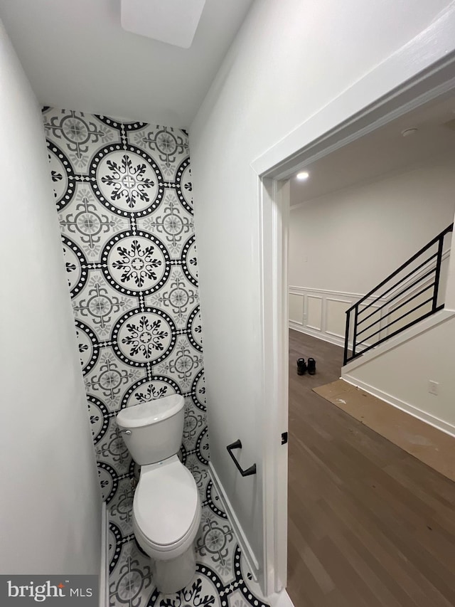 bathroom with toilet and wood finished floors