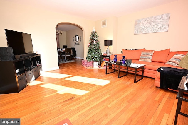 living room with a chandelier and wood-type flooring