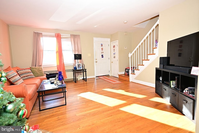 living room with hardwood / wood-style floors and radiator heating unit