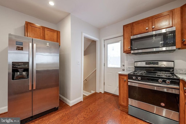 kitchen with light wood-type flooring and appliances with stainless steel finishes