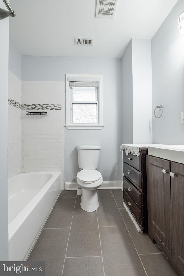 full bathroom with tile patterned floors, vanity, bathing tub / shower combination, and toilet