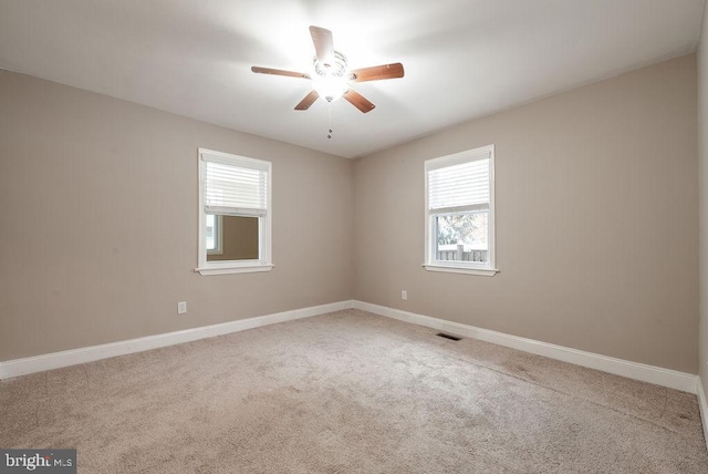 carpeted empty room featuring ceiling fan