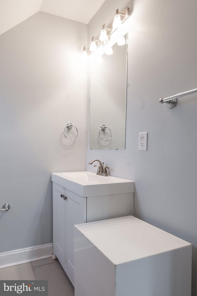 bathroom with vanity and vaulted ceiling