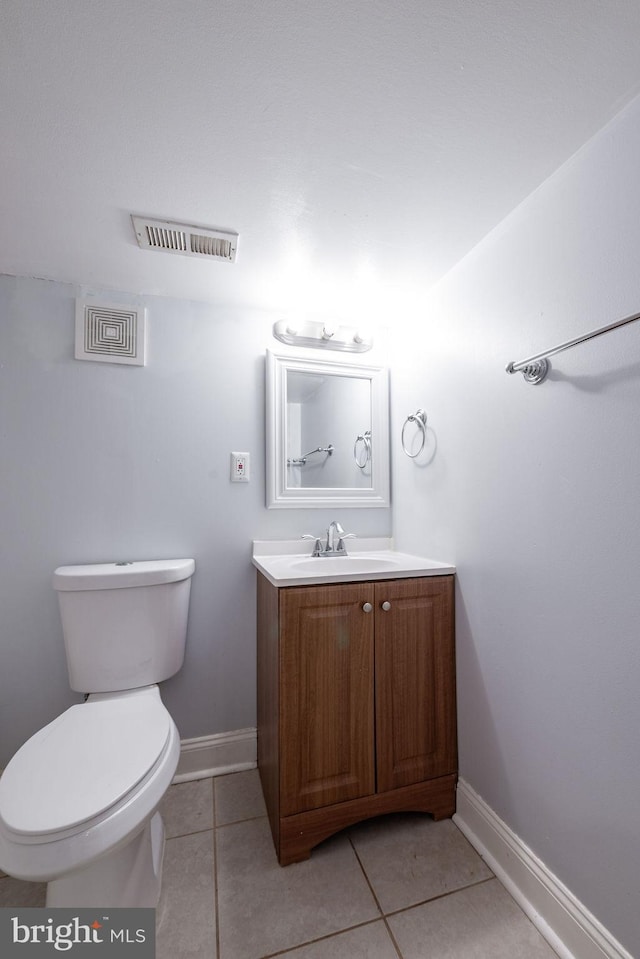 bathroom featuring tile patterned floors, vanity, and toilet