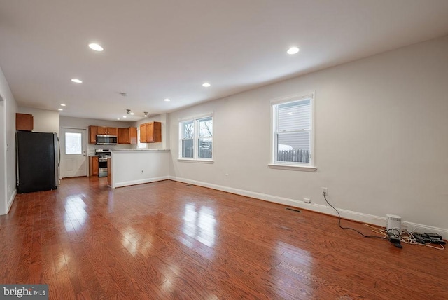 unfurnished living room with wood-type flooring