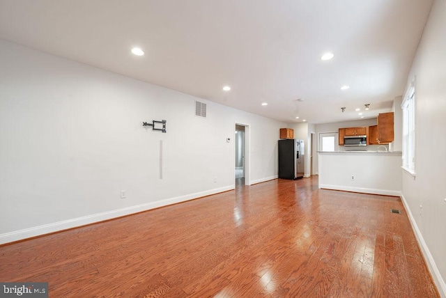 unfurnished living room with light wood-type flooring