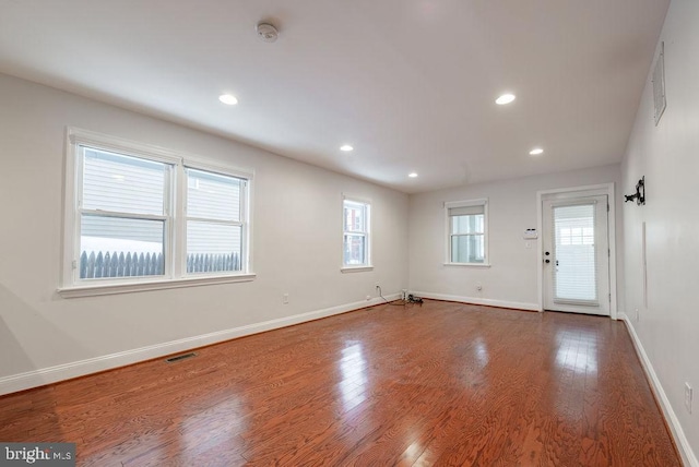 empty room featuring hardwood / wood-style flooring and plenty of natural light