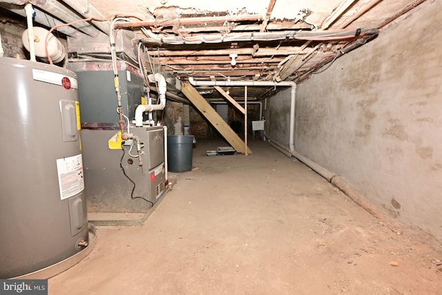 basement featuring heating unit and electric water heater