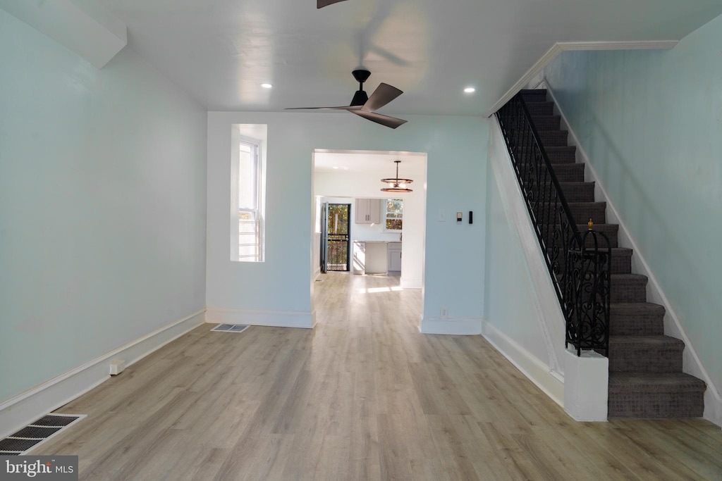 interior space featuring light wood-type flooring and ceiling fan