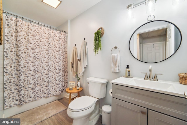 bathroom featuring toilet, curtained shower, wood-type flooring, and vanity