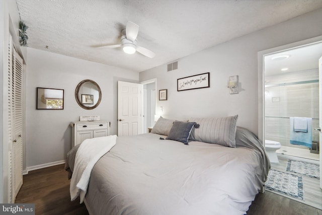 bedroom featuring ceiling fan, dark hardwood / wood-style flooring, ensuite bathroom, and a closet