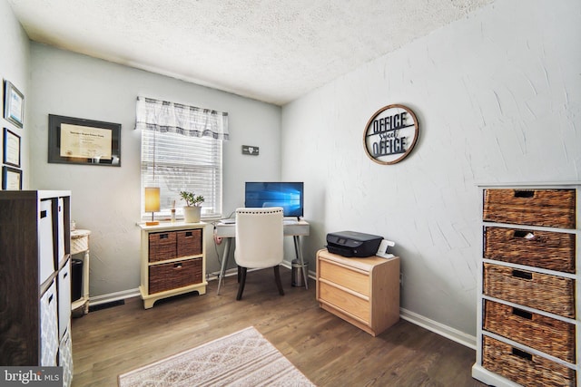 office space featuring a textured ceiling and dark hardwood / wood-style floors