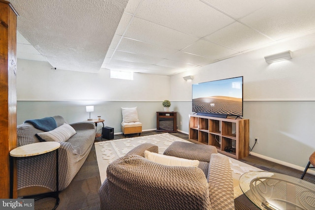 living room featuring a drop ceiling