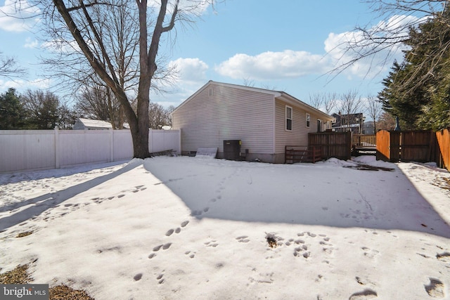 back of house featuring cooling unit and a wooden deck