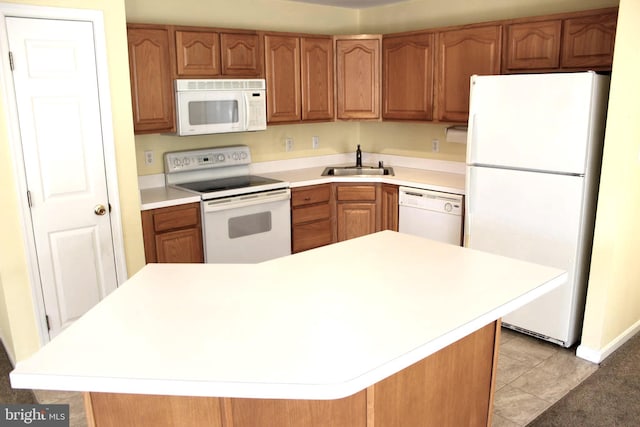 kitchen featuring a kitchen island, white appliances, sink, and light tile patterned floors