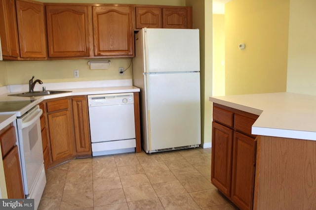 kitchen with white appliances, light tile patterned floors, and sink