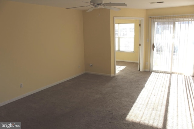 carpeted spare room featuring ceiling fan