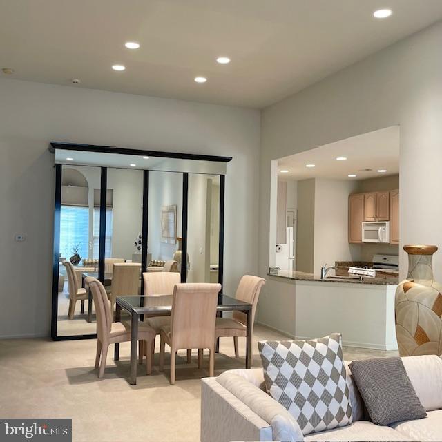 carpeted dining room featuring sink