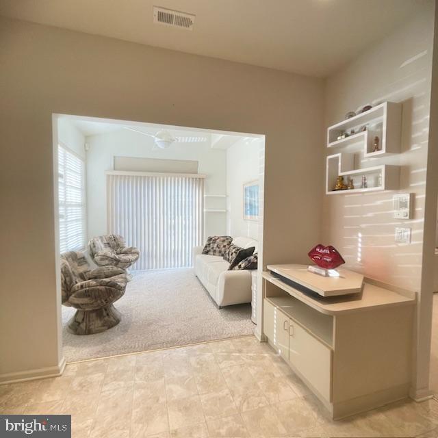 living area with light colored carpet