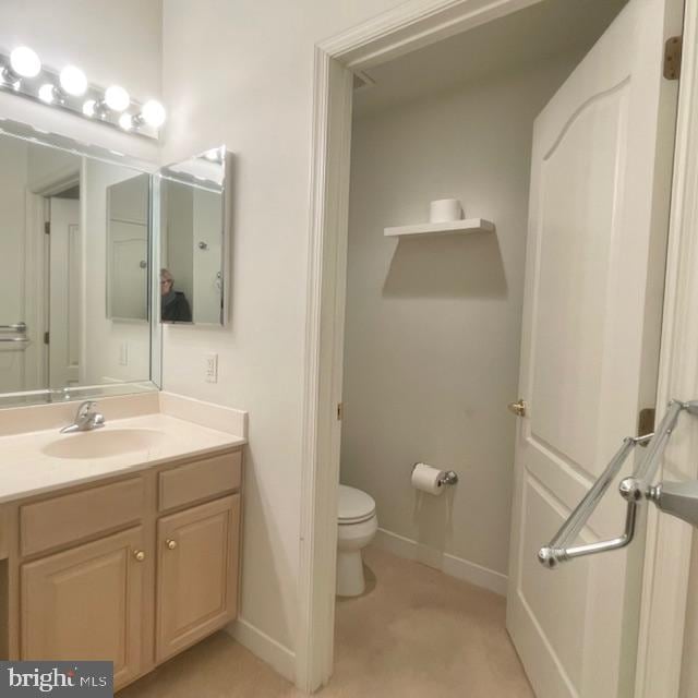 bathroom featuring vanity and toilet