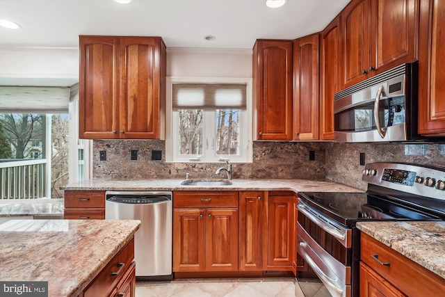 kitchen featuring light stone countertops, sink, tasteful backsplash, light tile patterned flooring, and appliances with stainless steel finishes