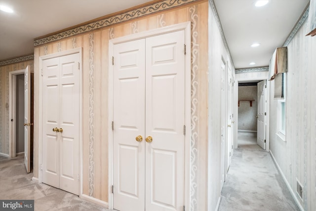 hallway featuring light colored carpet